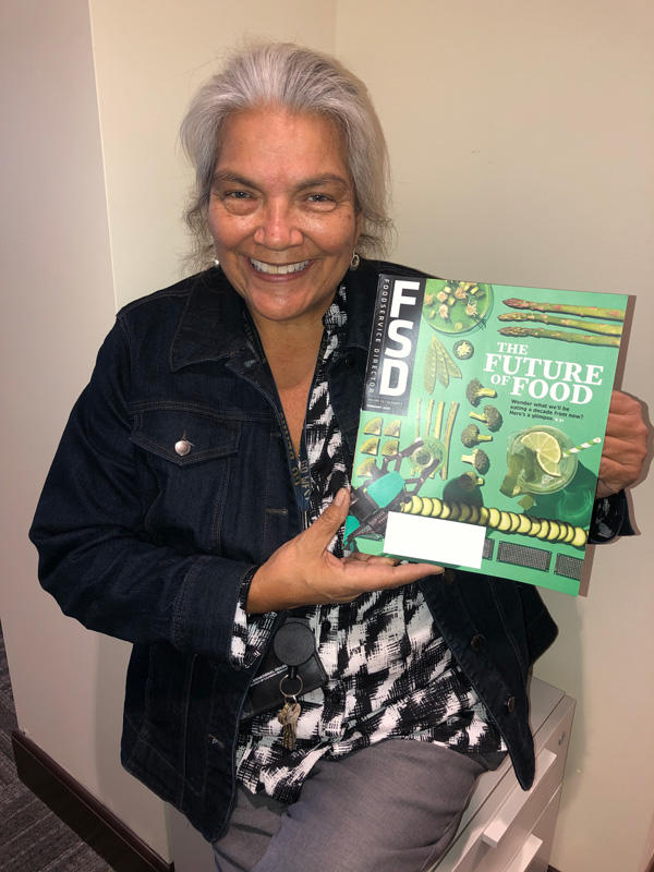 Maureen Spolidoro, I-House Dining Supervisor, holds a fresh copy of "The Future of Food" where I-House is featured